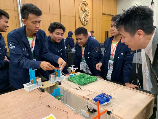 Students collaborating on robotics project at CodeFest education partnership event