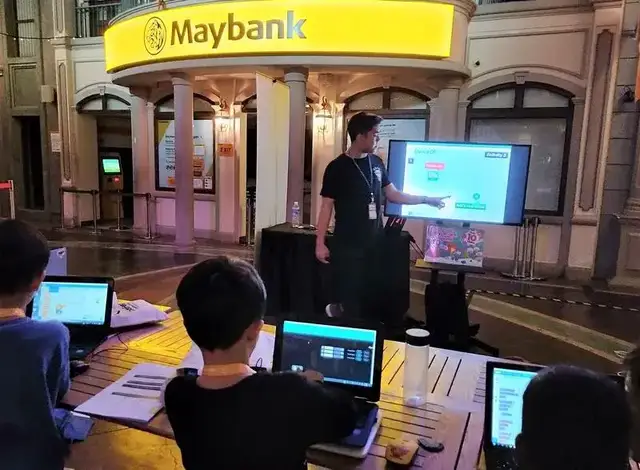 Instructor teaching Scratch coding outdoors at CodeFest